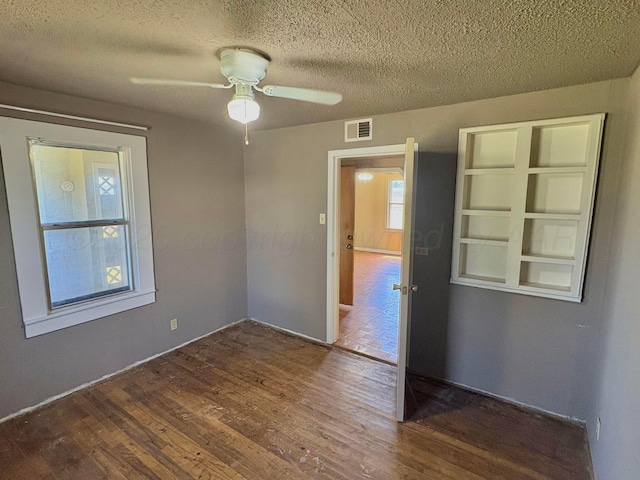 605 E 4th St, Panhandle, TX 79068 - spare room with wood finished floors, a ceiling fan, and a textured ceiling