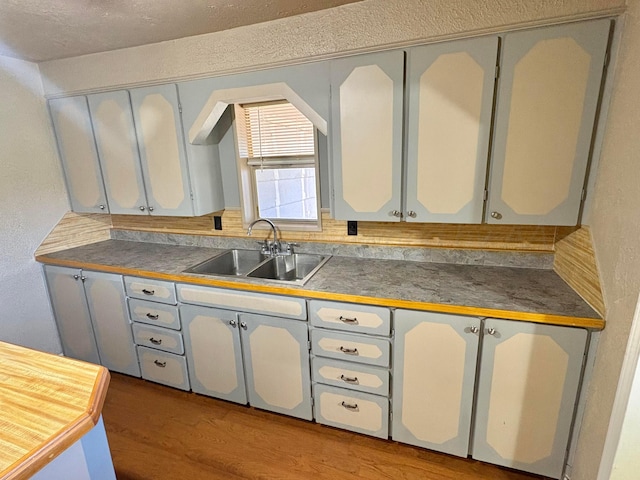 605 E 4th St, Panhandle, TX 79068 - kitchen with a sink, wood finished floors, and dark countertops