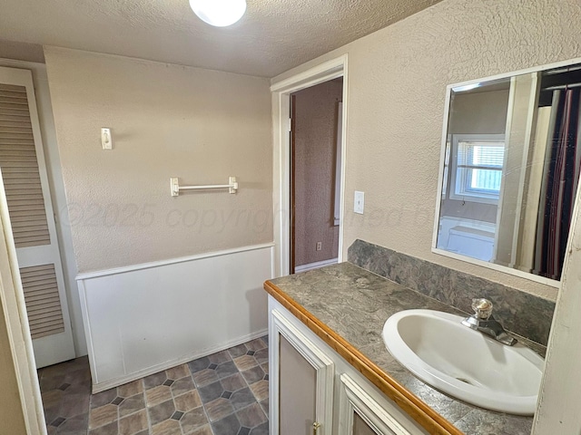 605 E 4th St, Panhandle, TX 79068 - bathroom with a textured wall, a textured ceiling, and vanity