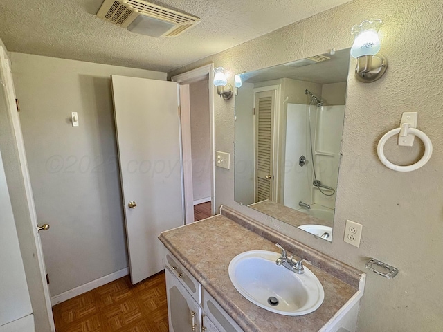 605 E 4th St, Panhandle, TX 79068 - bathroom with a textured ceiling, vanity, a textured wall, a shower, and baseboards