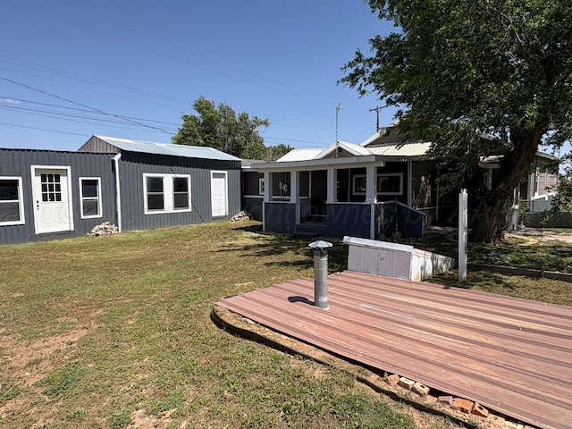 605 E 4th St, Panhandle, TX 79068 - rear view of property with a wooden deck, a yard, and a sunroom