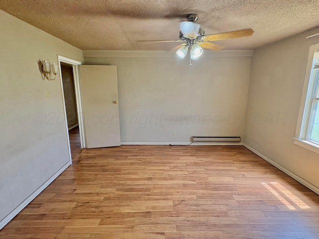 605 E 4th St, Panhandle, TX 79068 - unfurnished room with a baseboard heating unit, light wood-type flooring, ceiling fan, a textured ceiling, and baseboards
