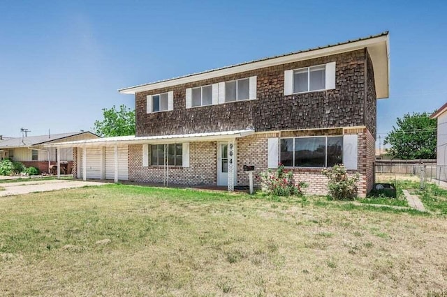 view of front of home with fence, an attached garage, driveway, a front yard, and brick siding