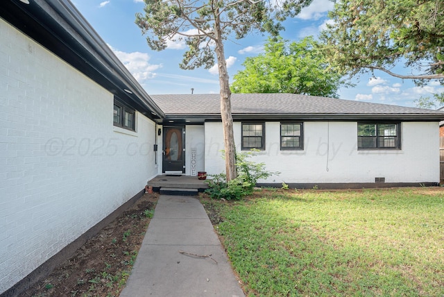 3701 Westlawn Ave, Amarillo, TX 79102 - entrance to property featuring a yard, brick siding, and a shingled roof