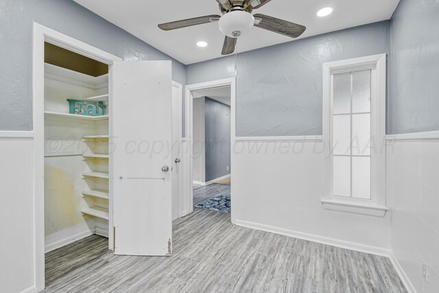 3701 Westlawn Ave, Amarillo, TX 79102 - unfurnished bedroom featuring wood finished floors, a wainscoted wall, ceiling fan, and recessed lighting
