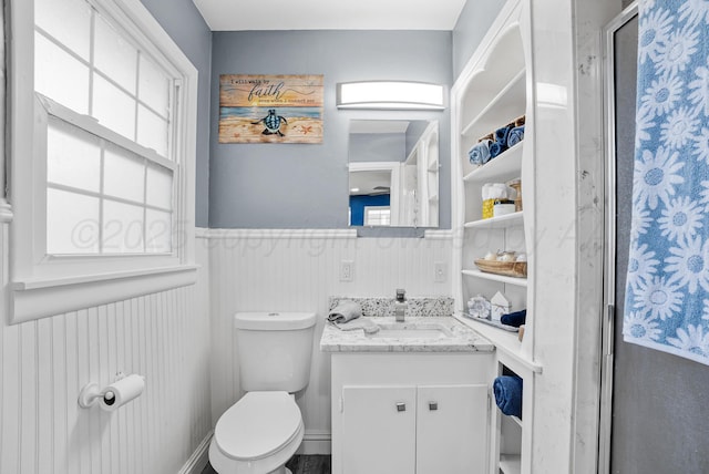 3701 Westlawn Ave, Amarillo, TX 79102 - bathroom featuring wainscoting, vanity, healthy amount of natural light, and a shower with door