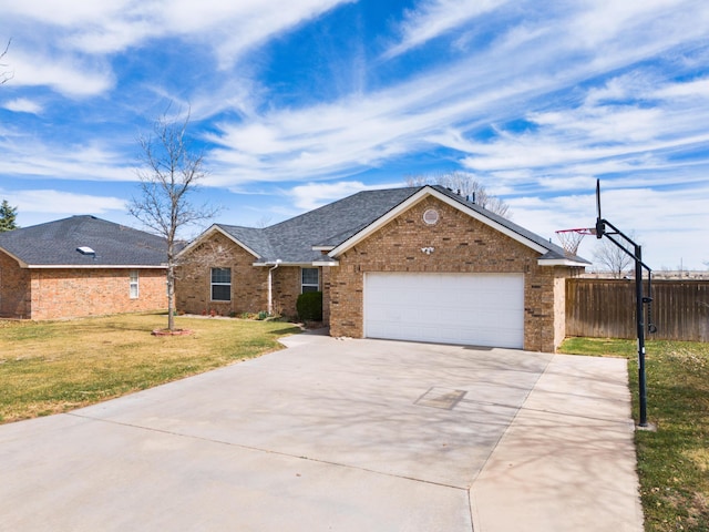 ranch-style home featuring a front yard, fence, driveway, a garage, and brick siding