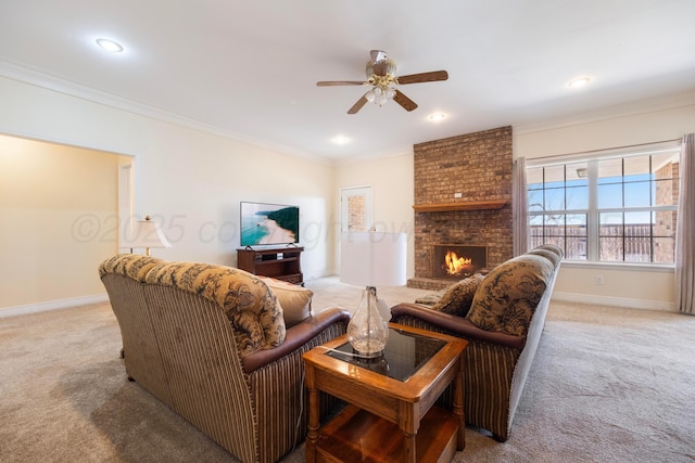 living area with crown molding, carpet, baseboards, and ceiling fan
