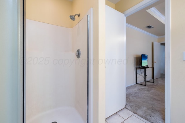 bathroom featuring a shower stall, visible vents, tile patterned floors, and ornamental molding