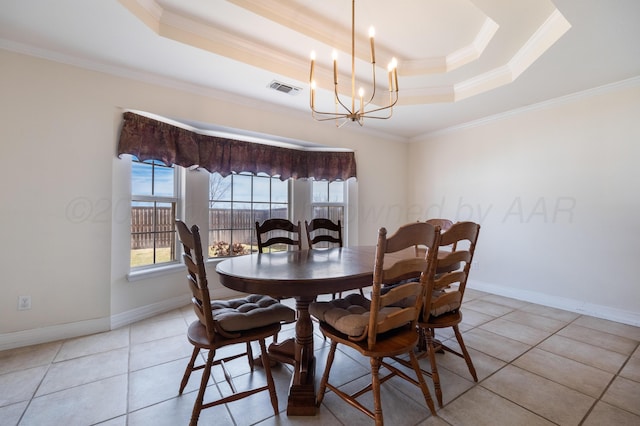 dining space featuring visible vents, baseboards, a tray ceiling, ornamental molding, and an inviting chandelier