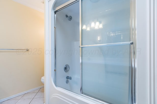 full bath with tile patterned flooring, toilet, baseboards, and shower / bath combination with glass door