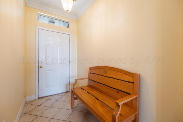 entryway with light tile patterned floors, baseboards, and crown molding