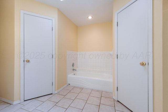 bathroom featuring tile patterned flooring, recessed lighting, a bath, and baseboards