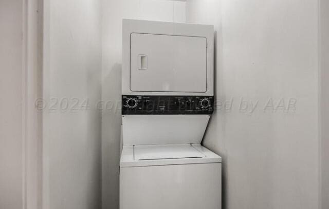 washroom with laundry area and stacked washer / drying machine