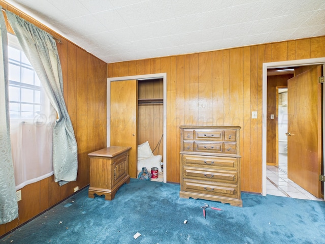 1108 Campanella Dr, Pampa, TX 79065 - unfurnished bedroom with carpet floors, wood walls, and a closet