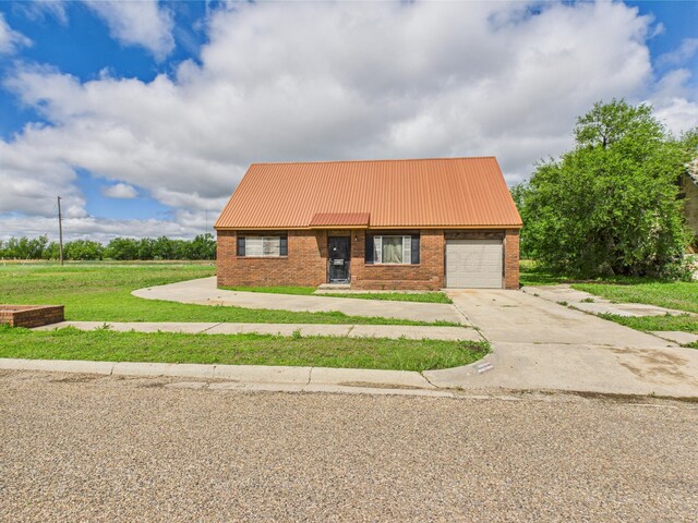 1108 Campanella Dr, Pampa, TX 79065 - view of front facade with a garage, metal roof, brick siding, a front yard, and driveway