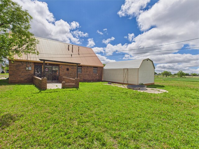 1108 Campanella Dr, Pampa, TX 79065 - rear view of property with a yard, an outdoor structure, brick siding, and a shed