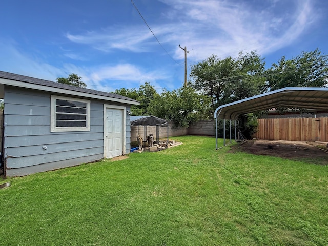 424 Santa Fe St, Borger, TX 79007 - view of yard featuring a detached carport and an outbuilding