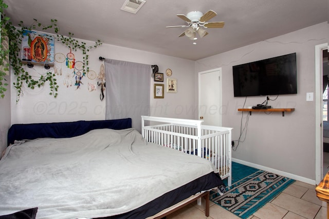 tiled bedroom featuring ceiling fan