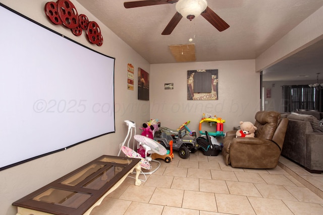 tiled cinema room featuring ceiling fan