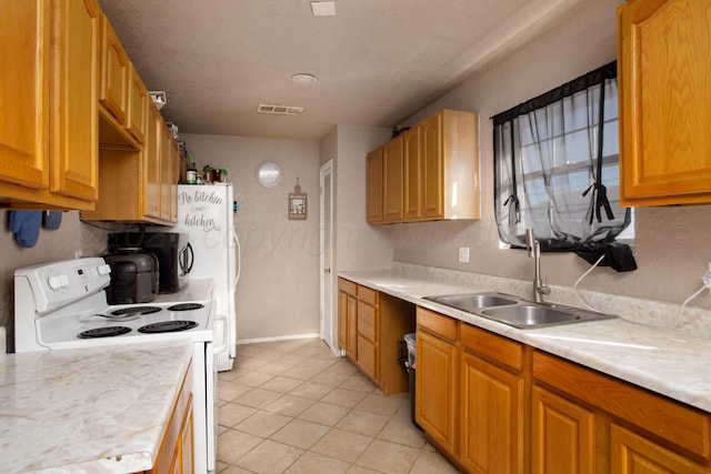 kitchen featuring white electric stove, sink, a textured ceiling, and light tile patterned floors