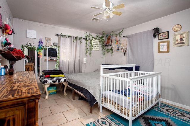 bedroom featuring ceiling fan and tile patterned flooring