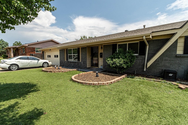 ranch-style house featuring central AC unit and a front lawn