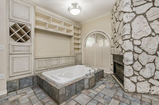 7402 Lynnlee Pl, Amarillo, TX 79121 - bathroom with stone tile flooring, ornamental molding, a fireplace, and a bath