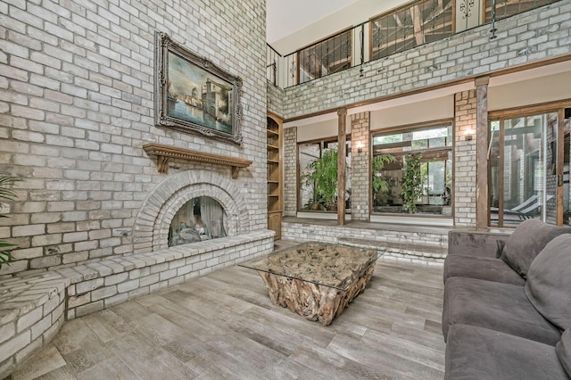 7402 Lynnlee Pl, Amarillo, TX 79121 - living area with wood finished floors, built in shelves, an outdoor brick fireplace, and a towering ceiling