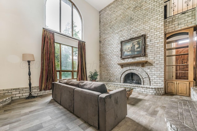 7402 Lynnlee Pl, Amarillo, TX 79121 - living room featuring a towering ceiling, a fireplace, and wood finished floors