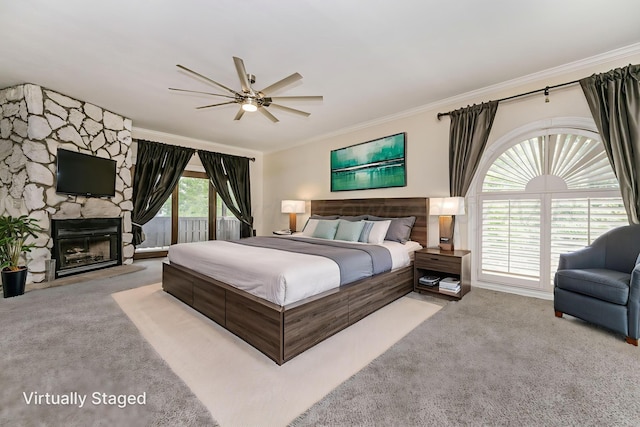 7402 Lynnlee Pl, Amarillo, TX 79121 - carpeted bedroom featuring ornamental molding, access to outside, a stone fireplace, and a ceiling fan