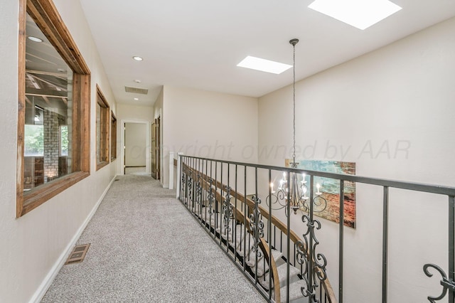 7402 Lynnlee Pl, Amarillo, TX 79121 - hallway featuring carpet, a chandelier, recessed lighting, and a skylight