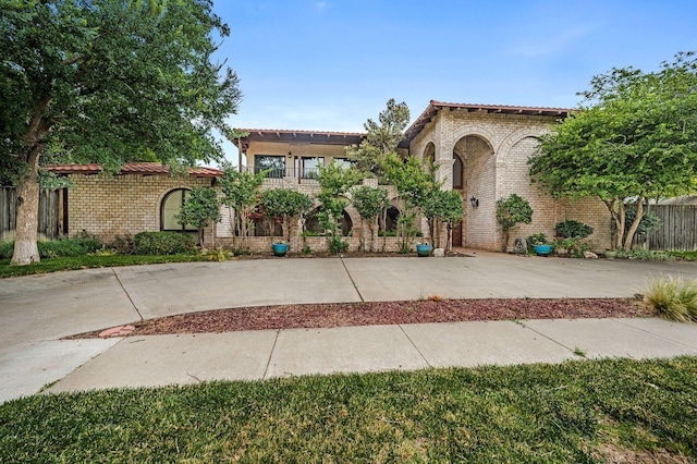 7402 Lynnlee Pl, Amarillo, TX 79121 - mediterranean / spanish-style house featuring brick siding and a tiled roof