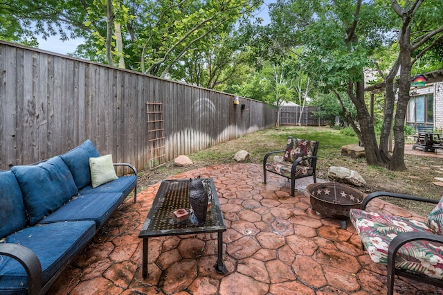 7402 Lynnlee Pl, Amarillo, TX 79121 - fenced backyard featuring a patio area and an outdoor living space with a fire pit