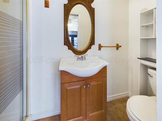 1924 N Dwight St, Pampa, TX 79065 - bathroom featuring toilet, vanity, tile patterned floors, and baseboards