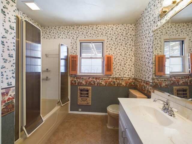 1924 N Dwight St, Pampa, TX 79065 - full bath featuring vanity, toilet, tile patterned floors, wallpapered walls, and heating unit