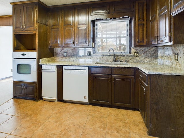 1924 N Dwight St, Pampa, TX 79065 - kitchen featuring white appliances, tasteful backsplash, dark brown cabinetry, a sink, and light tile patterned floors