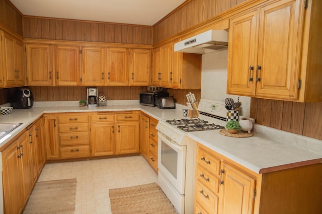 400 W 7th St, Panhandle, TX 79068 - kitchen with white range with gas cooktop, extractor fan, light countertops, and light flooring