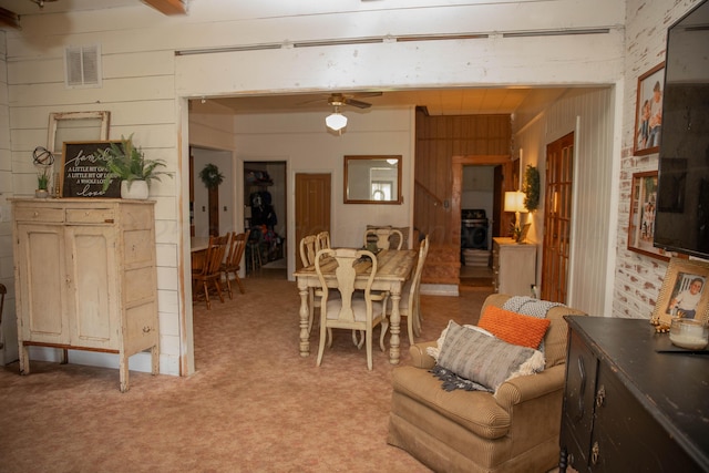 400 W 7th St, Panhandle, TX 79068 - dining space with light colored carpet, ceiling fan, and wood walls