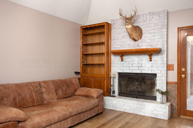 8001 Arbor St, Amarillo, TX 79110 - living room with wood finished floors, a fireplace, and a textured ceiling