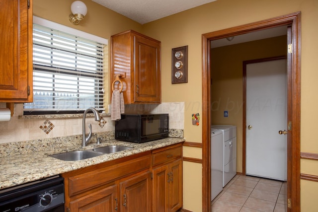 8001 Arbor St, Amarillo, TX 79110 - kitchen with black microwave, dishwashing machine, separate washer and dryer, and decorative backsplash