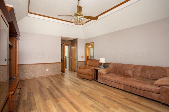 8001 Arbor St, Amarillo, TX 79110 - living room featuring wainscoting, light wood finished floors, ceiling fan, lofted ceiling, and a textured ceiling