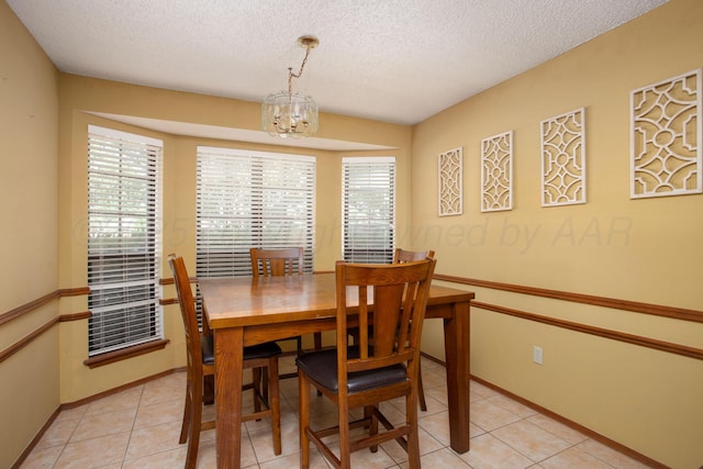 8001 Arbor St, Amarillo, TX 79110 - dining space featuring a chandelier, a textured ceiling, and light tile patterned floors
