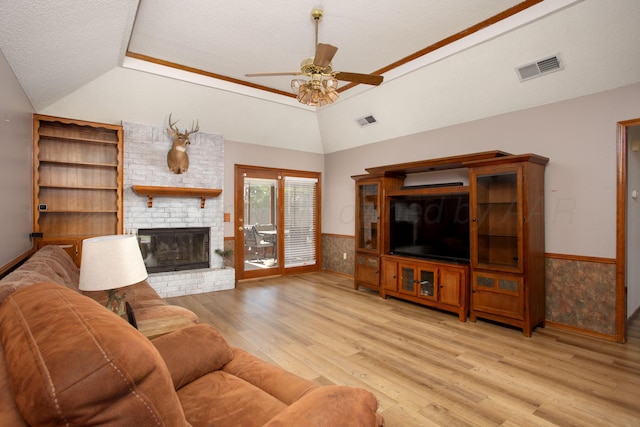 8001 Arbor St, Amarillo, TX 79110 - living room featuring vaulted ceiling, a ceiling fan, light wood finished floors, wainscoting, and a textured ceiling