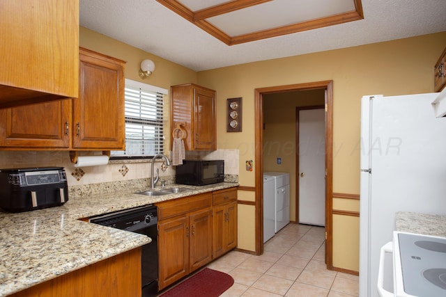 8001 Arbor St, Amarillo, TX 79110 - kitchen featuring black appliances, separate washer and dryer, brown cabinetry, and decorative backsplash