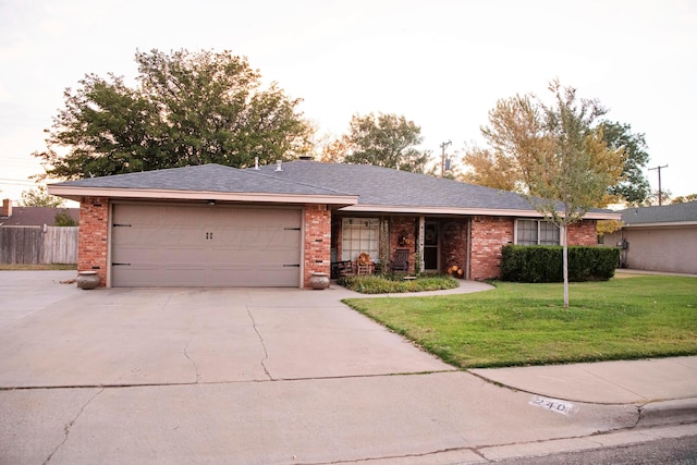 ranch-style house featuring a front lawn and a garage