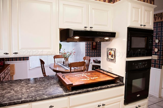 kitchen featuring white cabinetry, light tile patterned floors, and black appliances