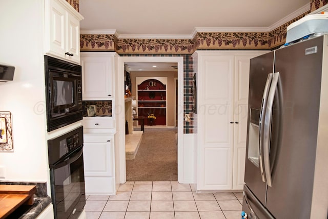 kitchen with black appliances, light tile patterned floors, crown molding, and white cabinets