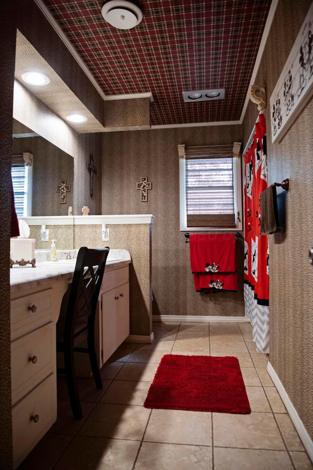 bathroom with vanity, tile patterned floors, crown molding, and plenty of natural light