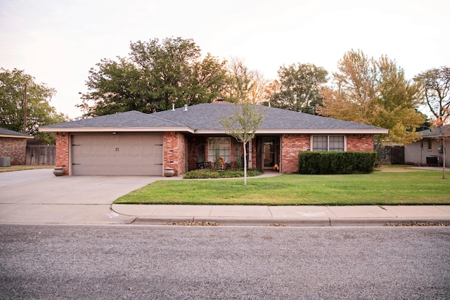 ranch-style home with a garage and a front yard